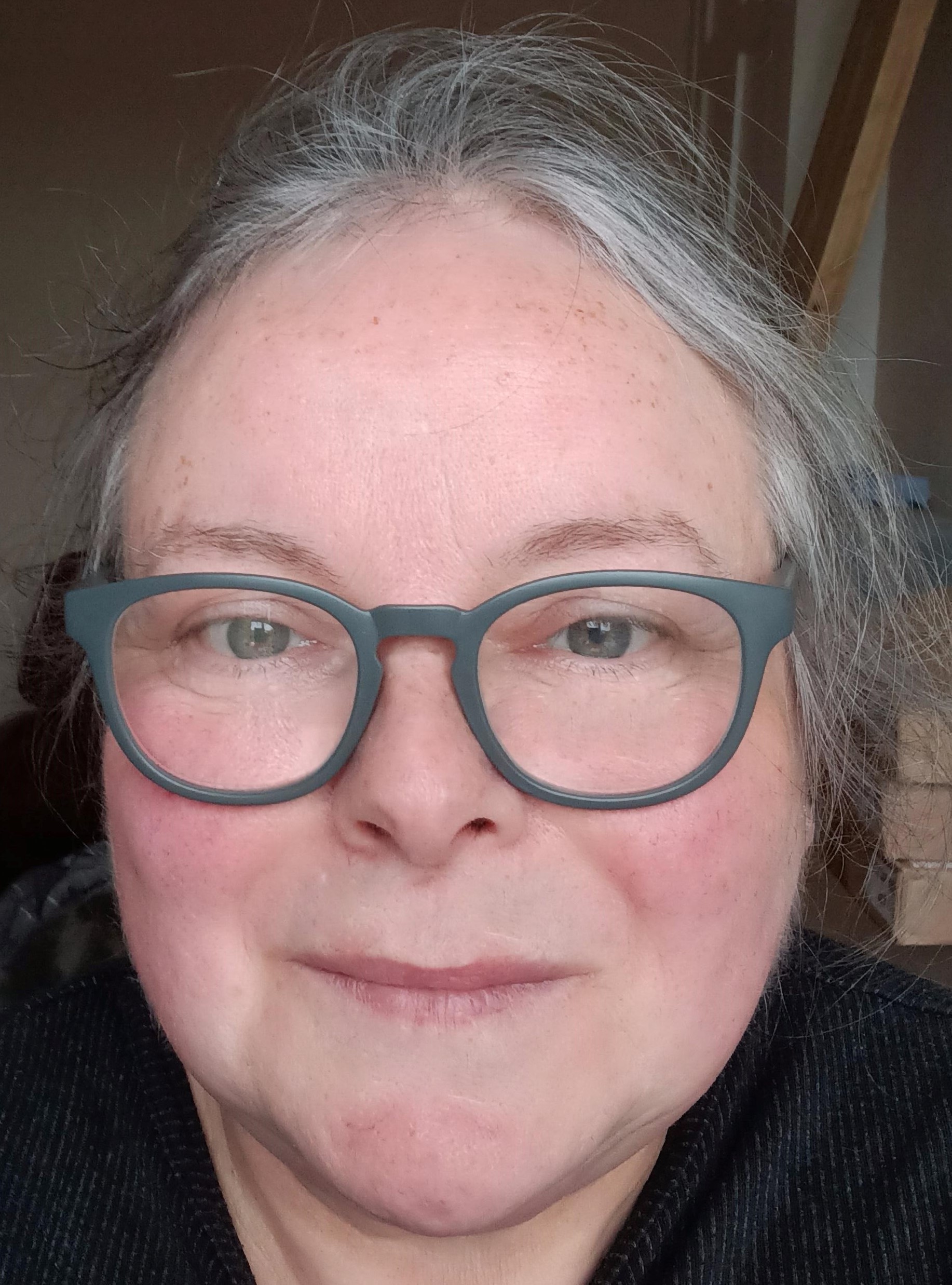 Image: Woman hair tied back and glasses